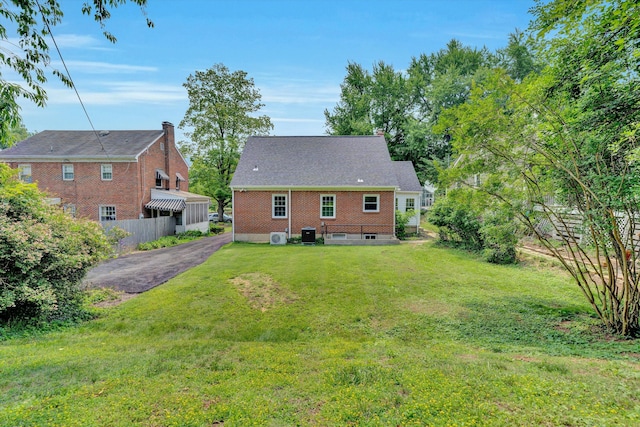 2619 Carolina Ave SW, Roanoke, VA 24014 - back of house featuring a yard, brick siding, and cooling unit