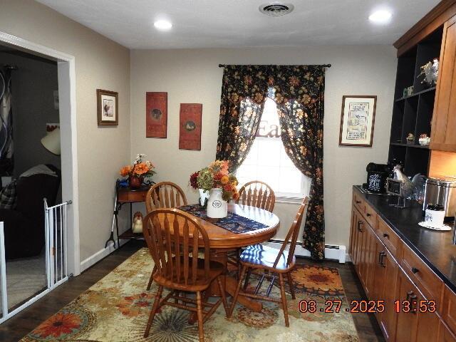 dining area featuring visible vents, recessed lighting, a baseboard radiator, and dark wood finished floors