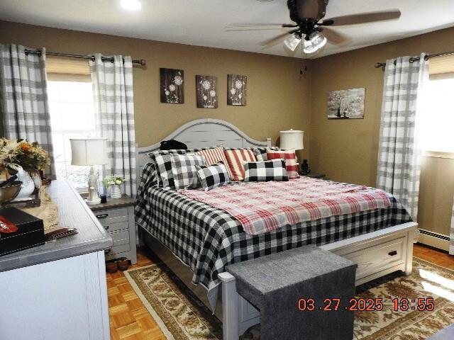 bedroom with ceiling fan and multiple windows