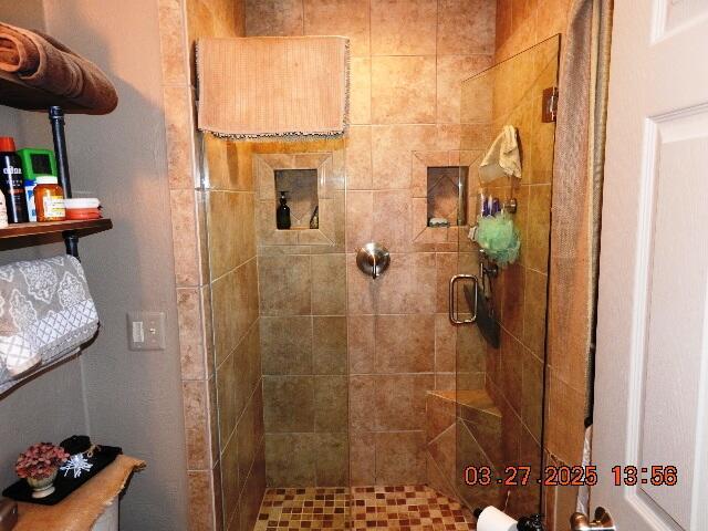 bathroom with a shower stall