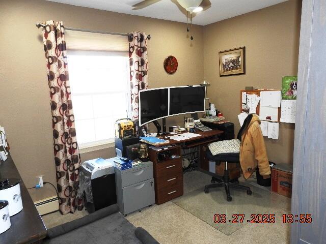 office area featuring a healthy amount of sunlight, baseboard heating, and ceiling fan