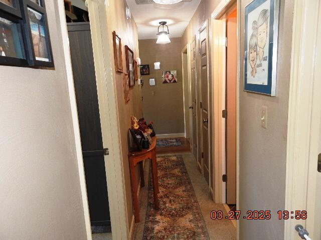 corridor featuring baseboards