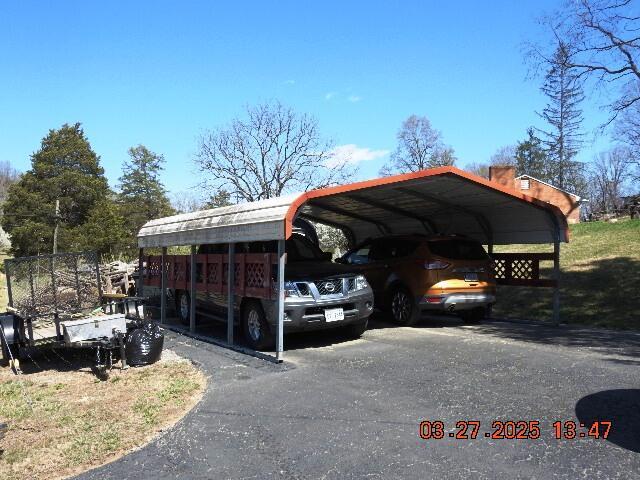 view of parking / parking lot featuring a carport