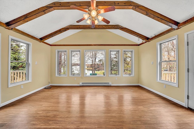 unfurnished room featuring a baseboard radiator, a healthy amount of sunlight, and wood finished floors