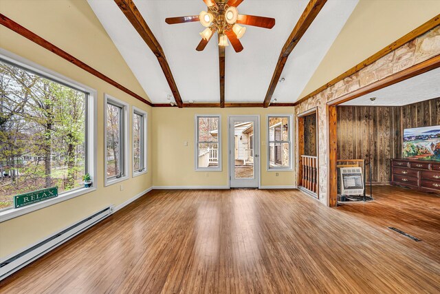 dining space with wood walls, light wood-style floors, a textured ceiling, and ceiling fan