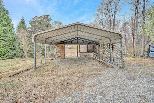 view of outbuilding featuring driveway and a carport
