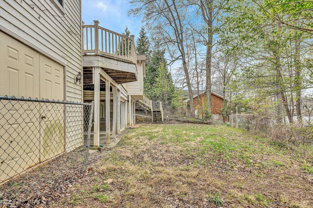 view of yard with stairs, fence, and a deck