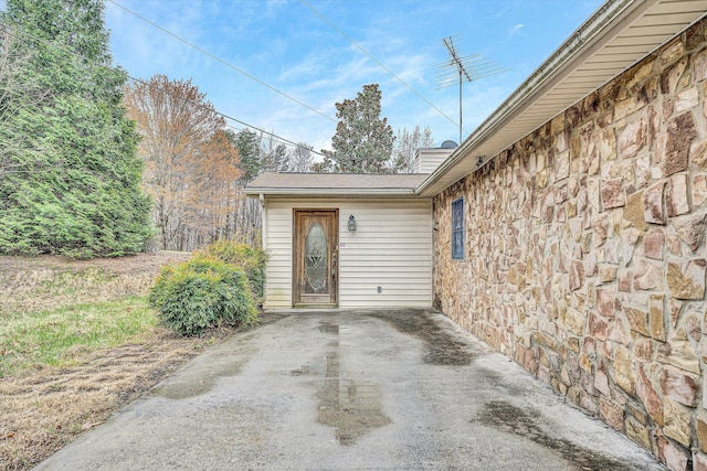 doorway to property featuring stone siding
