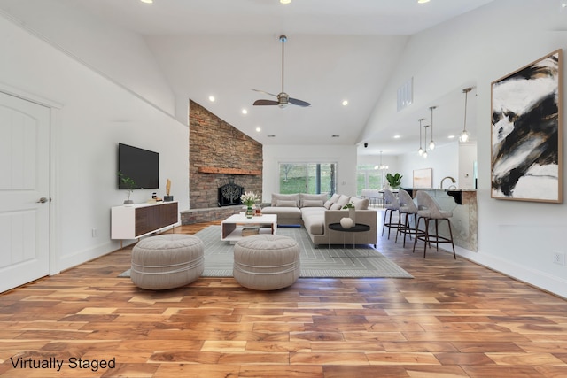 7425 Willow Leaf Cir, Roanoke, VA 24018 - living area with high vaulted ceiling, wood finished floors, ceiling fan, a fireplace, and baseboards