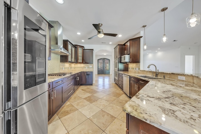 7425 Willow Leaf Cir, Roanoke, VA 24018 - kitchen with appliances with stainless steel finishes, a sink, wall chimney exhaust hood, arched walkways, and a ceiling fan
