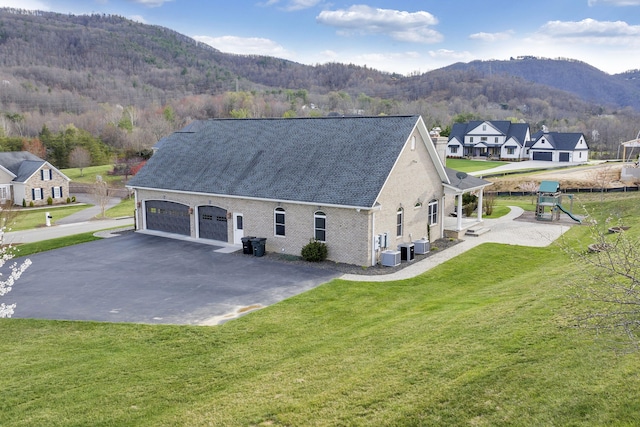 7425 Willow Leaf Cir, Roanoke, VA 24018 - view of side of home featuring a mountain view, a lawn, a playground, cooling unit, and a shingled roof
