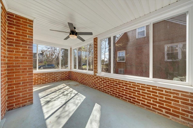 unfurnished sunroom with ceiling fan and plenty of natural light