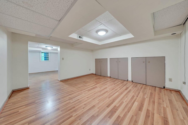interior space with baseboards, visible vents, and wood finished floors