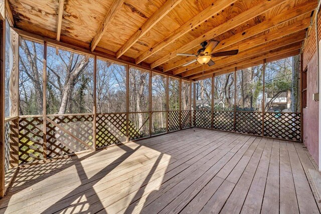 unfurnished sunroom featuring a ceiling fan