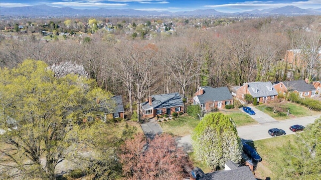 bird's eye view featuring a wooded view, a mountain view, and a residential view