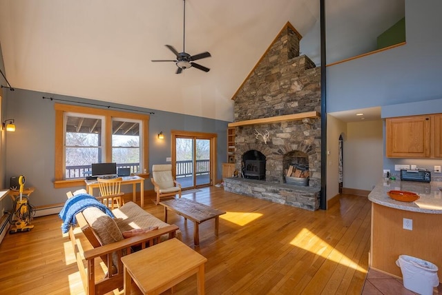 475 Loss Bent Rd NW, Riner, VA 24149 - living room featuring high vaulted ceiling, a ceiling fan, light wood-type flooring, baseboards, and a stone fireplace