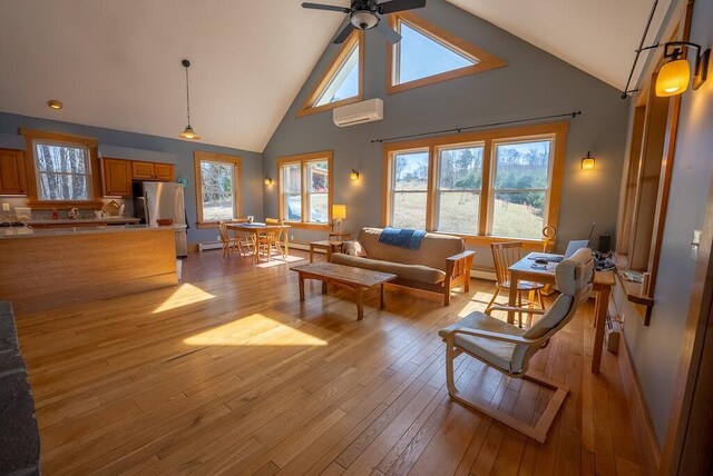 475 Loss Bent Rd NW, Riner, VA 24149 - living area with high vaulted ceiling, a wall mounted AC, light wood-type flooring, a ceiling fan, and a baseboard radiator
