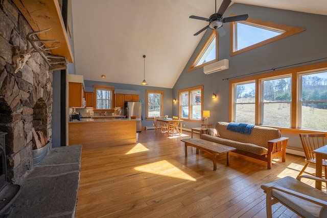 475 Loss Bent Rd NW, Riner, VA 24149 - living area featuring a wall mounted AC, high vaulted ceiling, a ceiling fan, light wood-type flooring, and baseboard heating