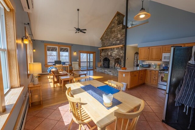 475 Loss Bent Rd NW, Riner, VA 24149 - dining space with ceiling fan, high vaulted ceiling, a fireplace, and light tile patterned floors