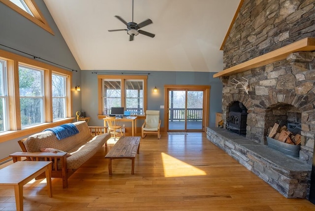 475 Loss Bent Rd NW, Riner, VA 24149 - living area with high vaulted ceiling, ceiling fan, a desk, light wood-style floors, and a wood stove