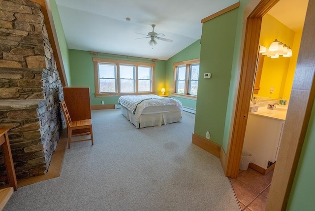 475 Loss Bent Rd NW, Riner, VA 24149 - carpeted bedroom with vaulted ceiling, a stone fireplace, baseboard heating, baseboards, and connected bathroom