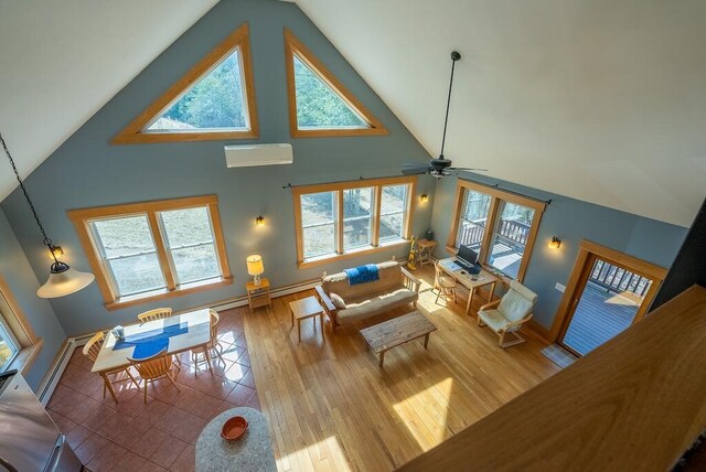 475 Loss Bent Rd NW, Riner, VA 24149 - living area with high vaulted ceiling, an AC wall unit, wood finished floors, a ceiling fan, and baseboards