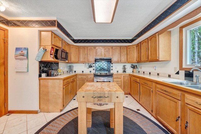kitchen with a sink, electric range, light tile patterned floors, and black microwave