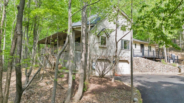view of home's exterior featuring stairway, driveway, and a garage