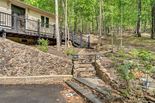 view of yard with stairs and a deck