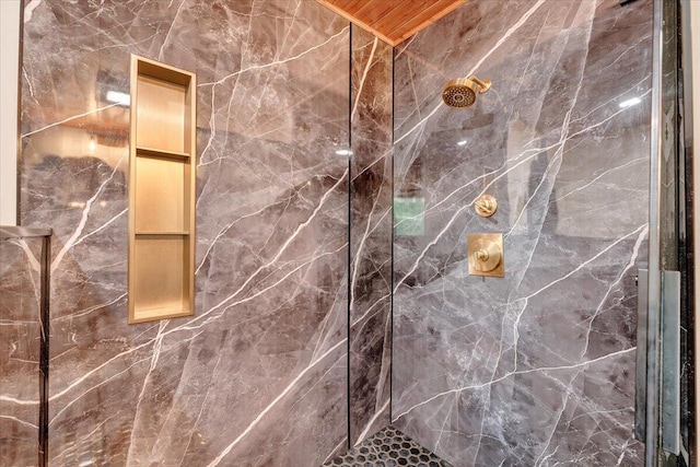 bathroom with a marble finish shower