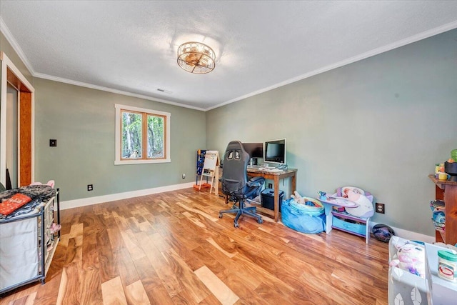 office area with crown molding, baseboards, and wood finished floors