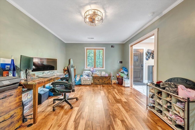 office space featuring a textured ceiling, ornamental molding, and wood finished floors