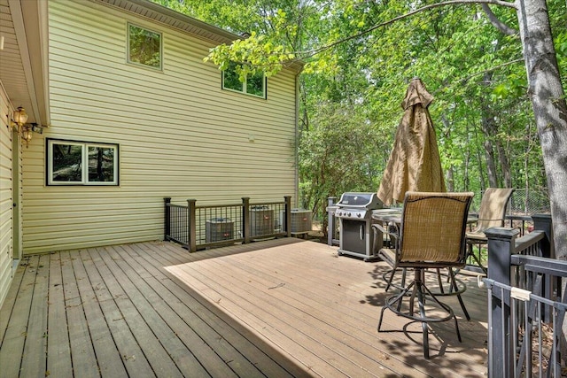 deck with outdoor dining area and area for grilling