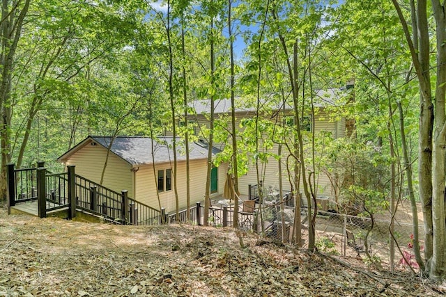 view of home's exterior with roof with shingles