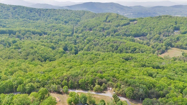 drone / aerial view featuring a view of trees and a mountain view