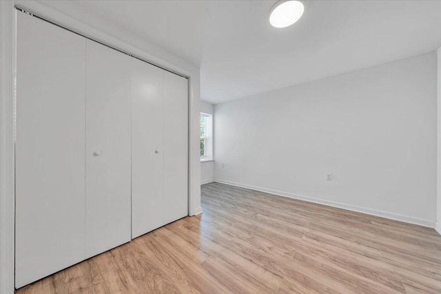 1113 17th St SE, Roanoke, VA 24013 - unfurnished bedroom featuring light wood-style floors, baseboards, and a closet