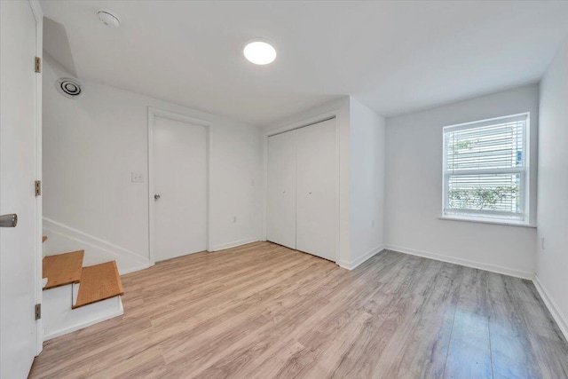 1113 17th St SE, Roanoke, VA 24013 - unfurnished bedroom featuring baseboards, a closet, and light wood-type flooring