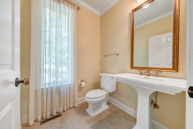half bath featuring tile patterned floors, crown molding, toilet, baseboards, and visible vents