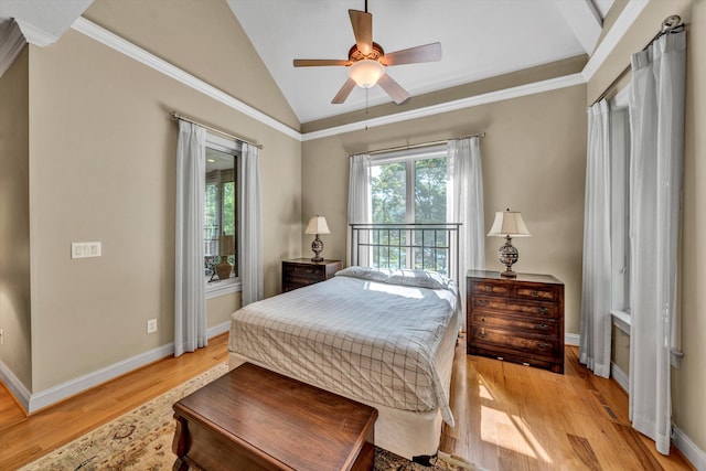 bedroom featuring light wood-style floors, baseboards, multiple windows, and vaulted ceiling