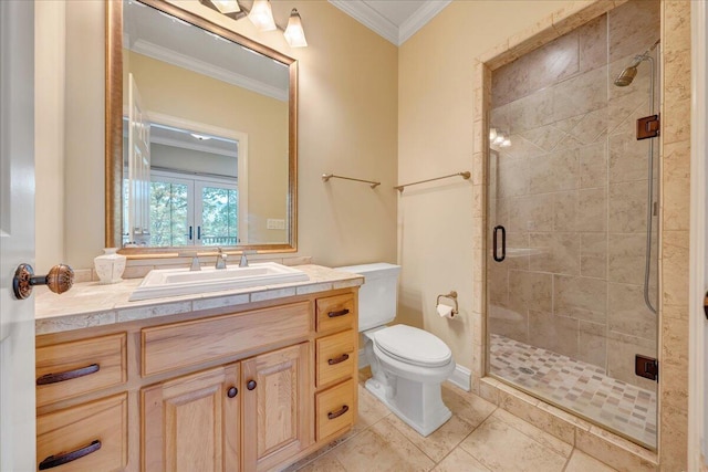 bathroom with toilet, vanity, crown molding, and a stall shower