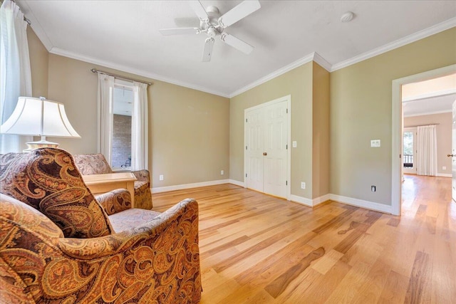 sitting room featuring baseboards, ornamental molding, light wood-style flooring, and ceiling fan