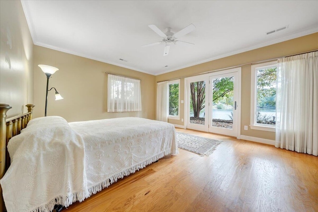 bedroom with access to exterior, visible vents, multiple windows, and ornamental molding