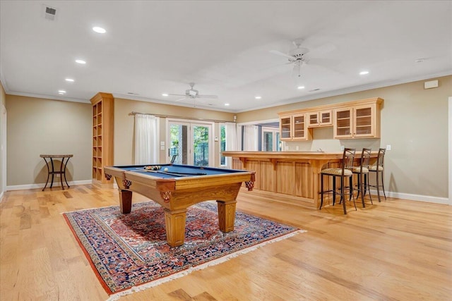 playroom with a ceiling fan, ornamental molding, and light wood-style flooring