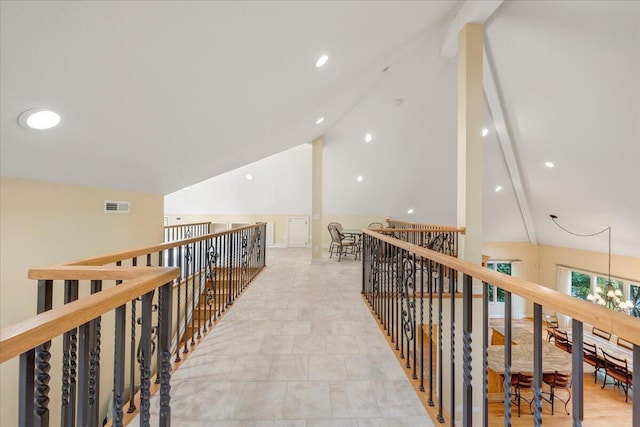 hallway with recessed lighting, an upstairs landing, lofted ceiling, and visible vents