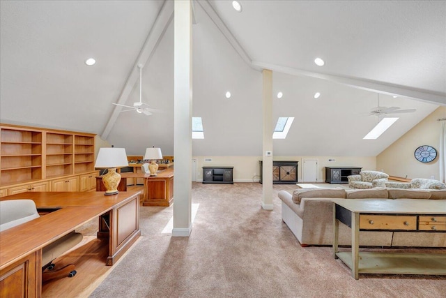living room featuring light colored carpet, recessed lighting, baseboards, vaulted ceiling with skylight, and ceiling fan