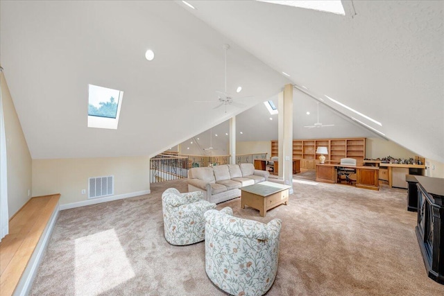 carpeted living area with lofted ceiling with skylight, a ceiling fan, baseboards, and visible vents