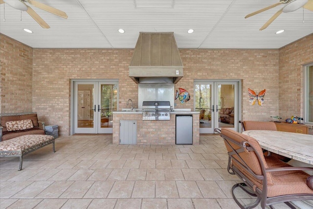 view of patio with french doors, grilling area, outdoor dining space, a sink, and ceiling fan