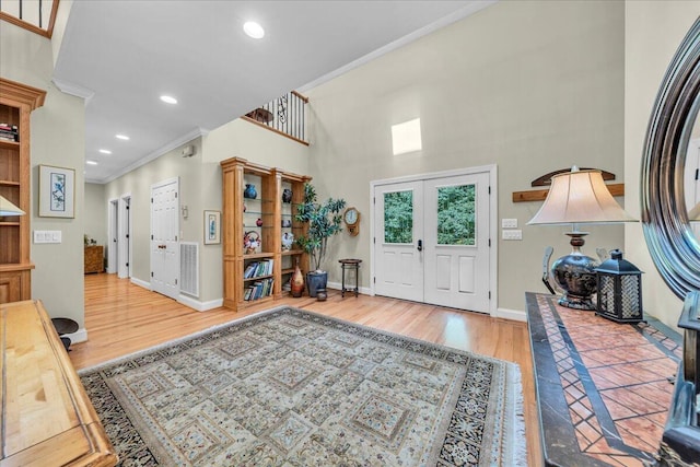 entrance foyer with recessed lighting, crown molding, baseboards, and wood finished floors