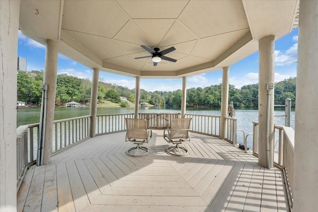 wooden terrace with a ceiling fan and a water view