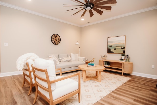 living room featuring a ceiling fan, light wood-style flooring, baseboards, ornamental molding, and recessed lighting